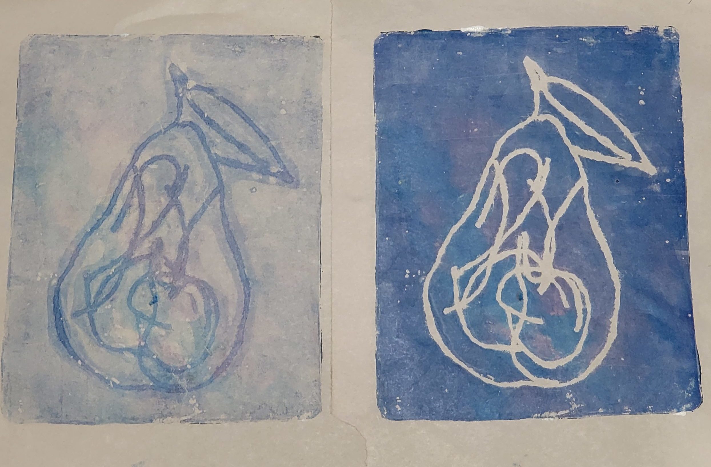 2 prints of pears in blue with purple tinges. The one on the left is the first print, where the outline of the pear and the internal texture is left blank with paint filling in the rest. The one on the right, the target image, has the most paint where the yarn was.